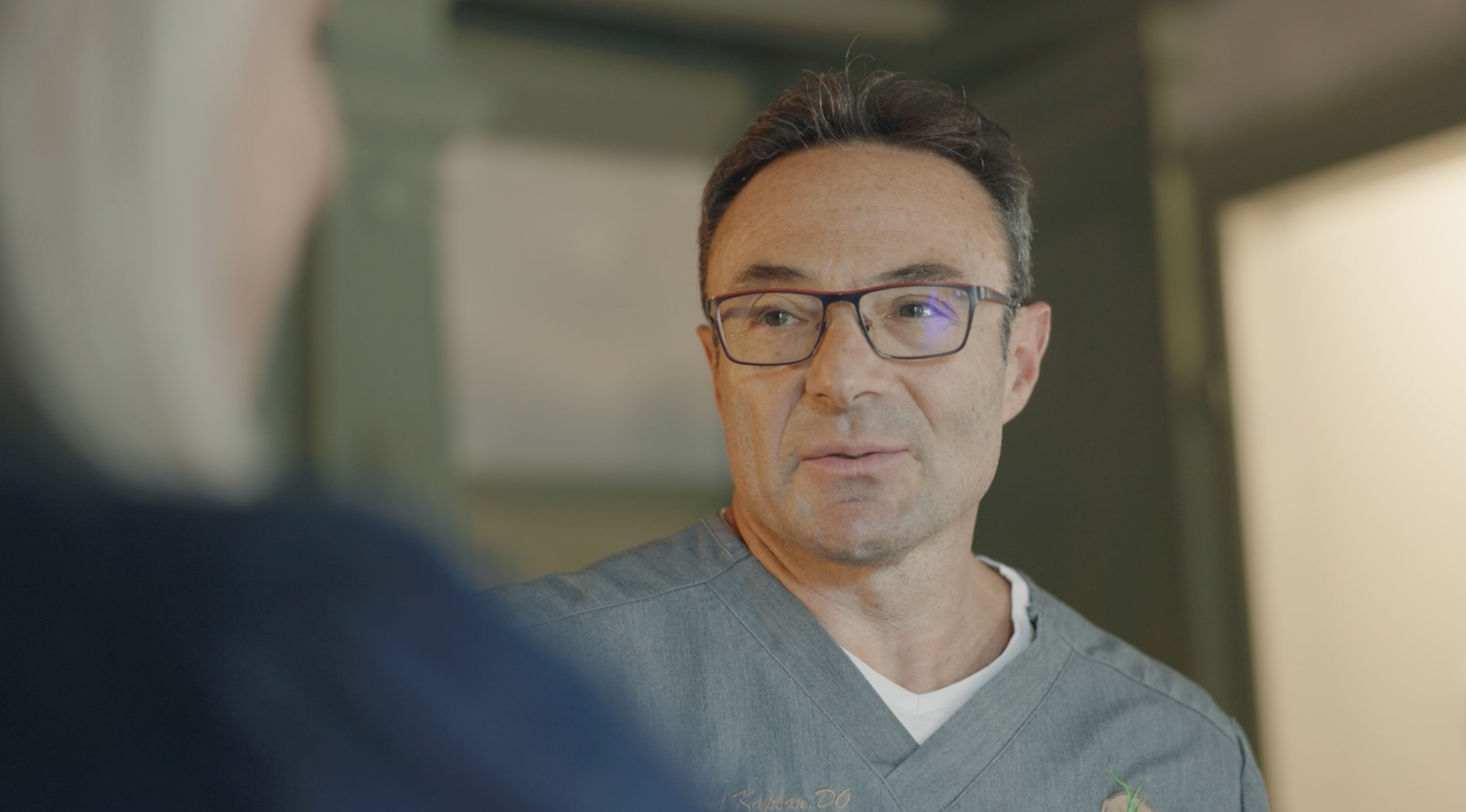 OWM provider listening closely to a patient during a chronic pain consultation