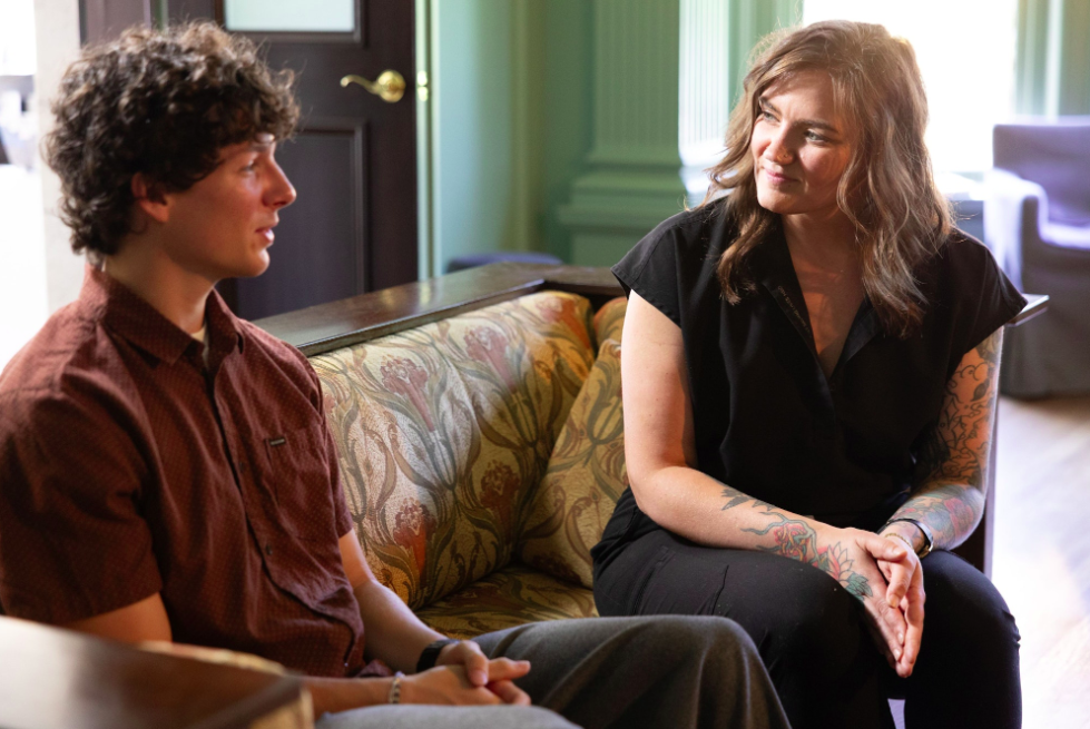 OWM provider talking with a patient on a sofa during a functional medicine consultation